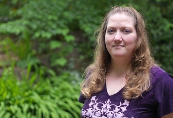Karolyn H, trees in background, photo by Jordan Herrera